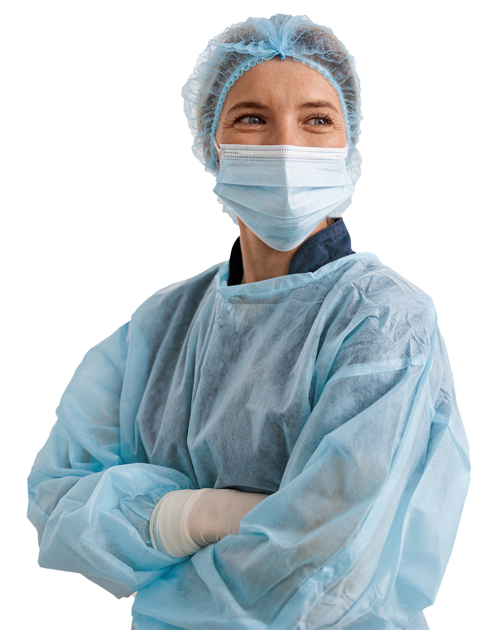 Female surgeon in sterile gown with mask and gloves, arms crossed